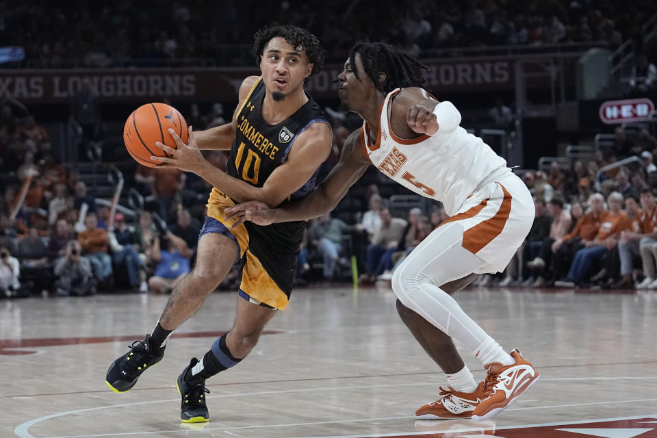 Texas A&M-Commerce guard Alonzo Dodd (10) drives against Texas guard Marcus Carr (5) during the first half of an NCAA college basketball game in Austin, Texas, Tuesday, Dec. 27, 2022. (AP Photo/Eric Gay)