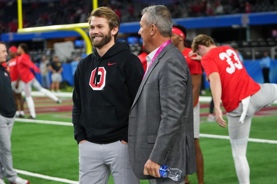 Former Ohio State quarterbacks coach Corey Dennis, left, has joined Mississippi's football program as an analyst.