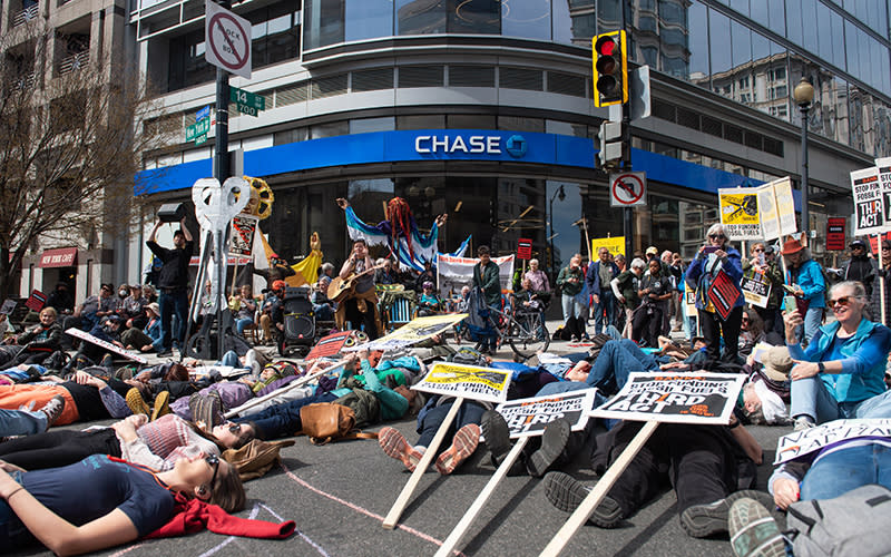 Protesters for the “Stop Dirty Banks” movement participate in a ”die-in” at a Chase Bank in downtown Washington, D.C.