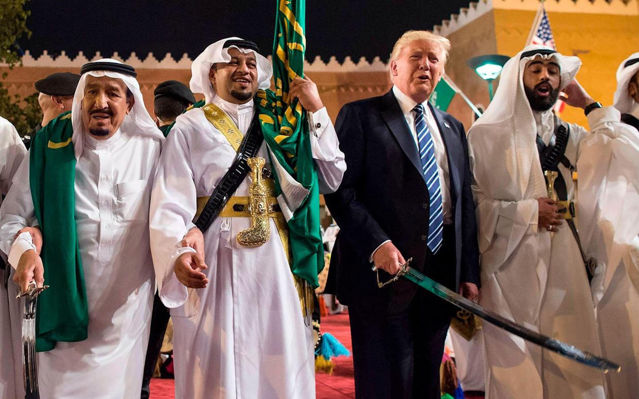  US President Donald Trump (2nd-R) and Saudi Arabia's King Salman bin Abdulaziz al-Saud (L) dancing with swords at a welcome ceremony ahead of a banquet at the Murabba Palace in Riyadh - AFP