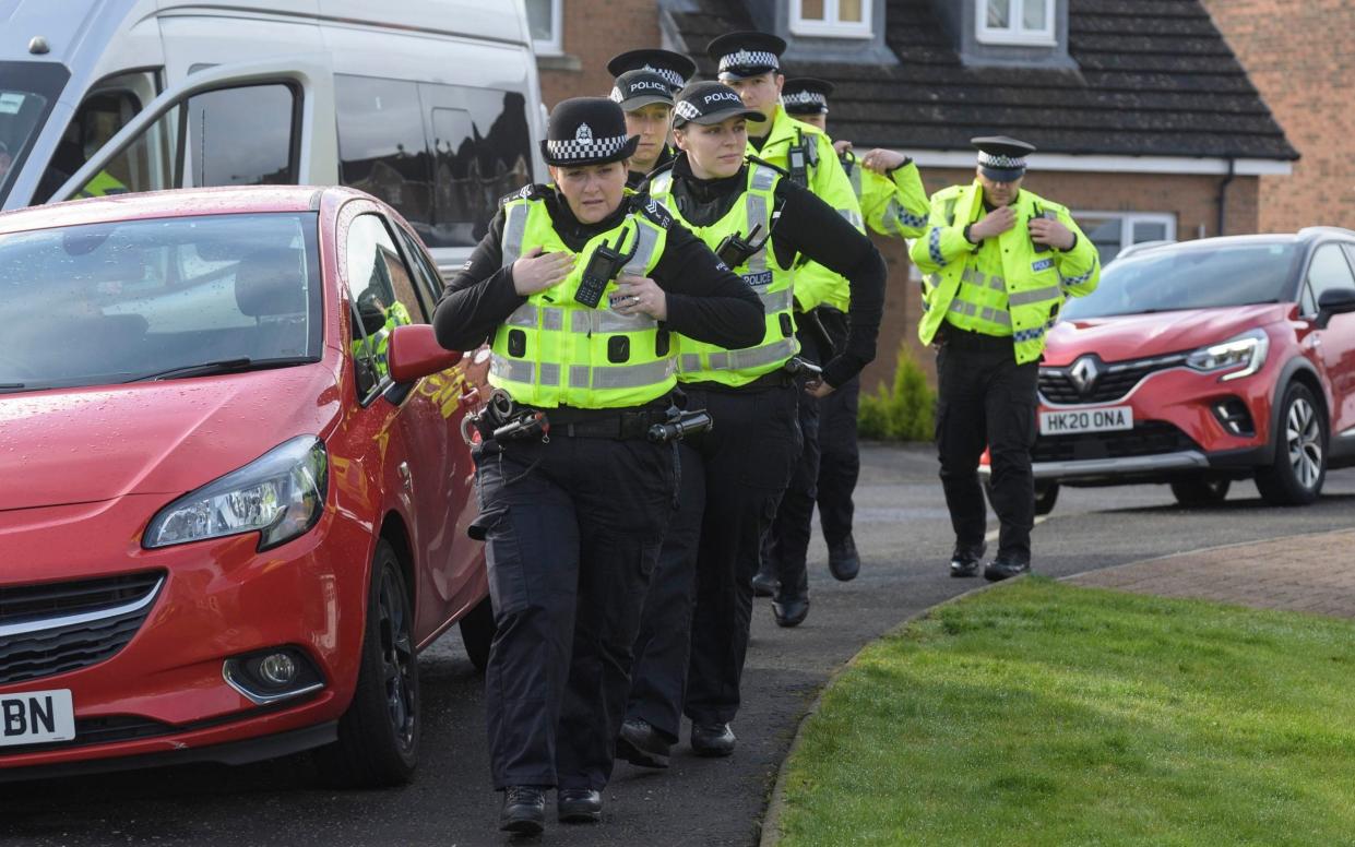 Police Scotland officers are pictured this morning outside the home of Peter Murrell and Nicola Sturgeon - Wattie Cheung