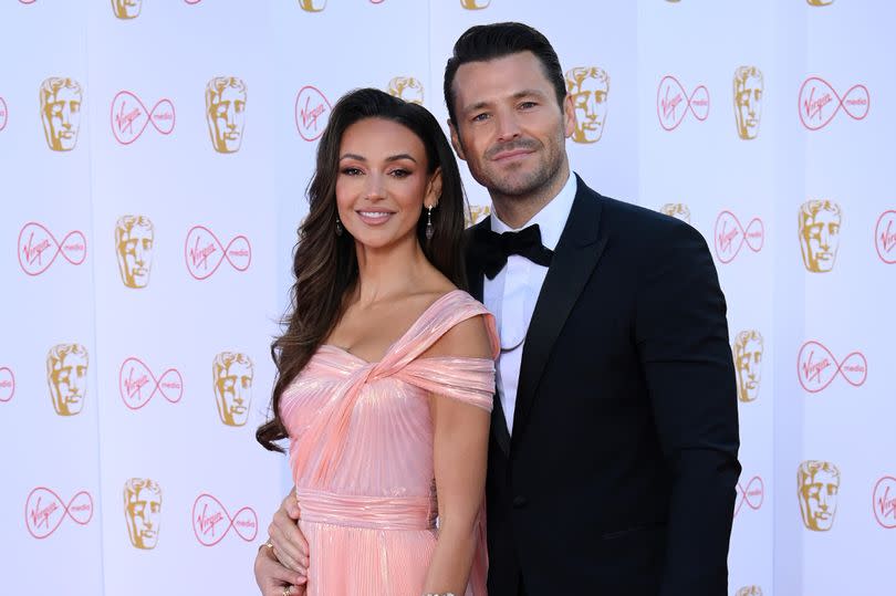 Michelle Keegan and Mark Wright pose on a red carpet