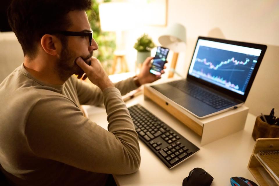 Investor making decision sitting at computer