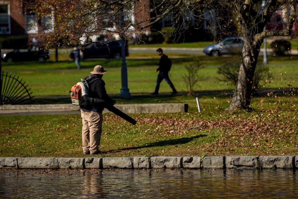 A worker clears fall foliage with a leaf blower at Edgemont Memorial Park in Montclair on Wednesday November 6, 2019. 