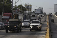 Soldiers drive ahead of Health Ministry trucks transporting COVID-19 vaccines that El Salvador's government is donating to Honduras as they depart San Salvador, El Salvador, Thursday, May 13, 2021. (AP Photo/Salvador Melendez)