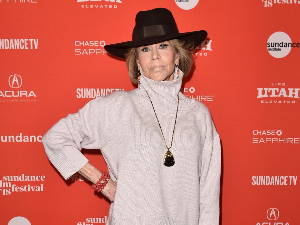 Jane in a wide hat and turtleneck posing in front of a Sundance backdrop.