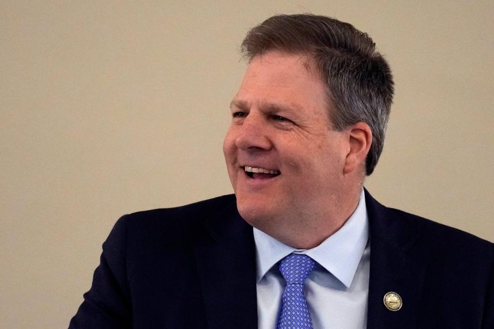 New Hampshire Gov. Chris Sununu laughs during his State of the State address at the State House, Thursday, Feb. 15, 2024, in Concord.