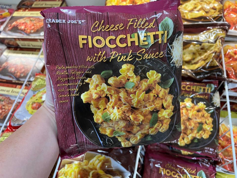 The writer holds a bag of cheese-filled fioccheti