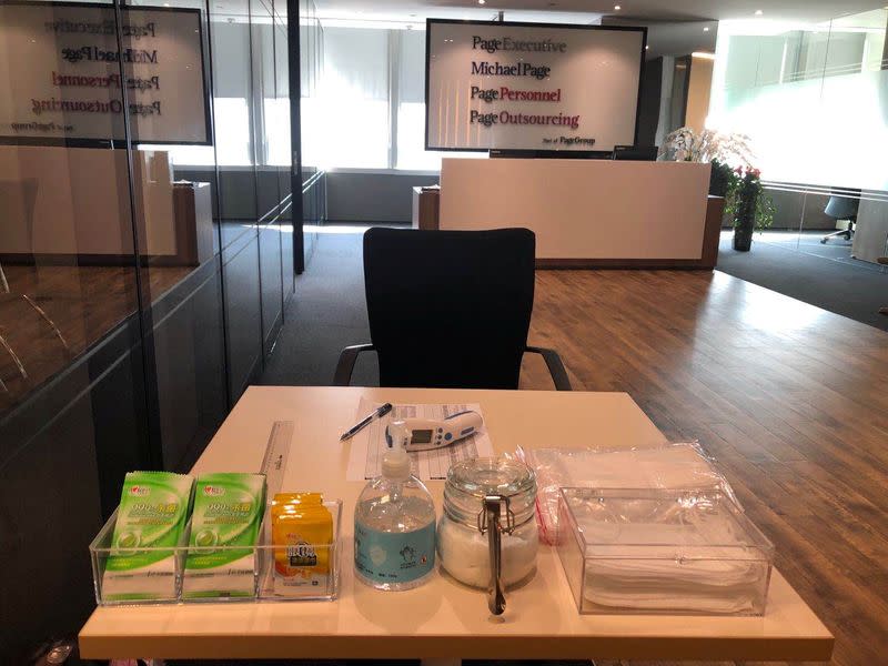 A thermometer, hand sanitizer and masks are pictured in the reception area at PageGroup's office after reopening, as the coronavirus disease (COVID-19) continues, in Shanghai
