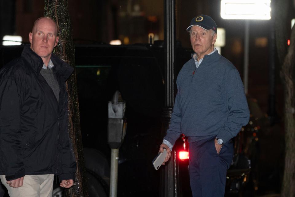 President Joe Biden reacts after hearing a loud bang as he leaves his campaign headquarters in Wilmington, Del., Sunday, Dec. 17, 2023.