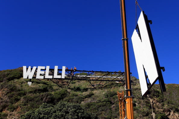 Workers install Wellington Airport's 'Wellington Blown Away' sign on July 27, 2012 in Wellington, New Zealand. The city was originally planning to put up a 'Wellywood' sign in 2010 to promote the local film industry but due to a public backlash decided to erect the sign designed by Matt Sellars and Raymond McKay. (Photo by Hagen Hopkins/Getty Images)