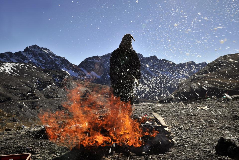 A yatiri (Aymara priest)  performs a ceremony to thank the Pachamama (Mother Earth) on August 1, 2013 at La Cumbre, 25 km from La Paz. August is a month dedicated to celebrate the Andean godess. AFP/PHOTO/AIZAR RALDES        (Photo credit should read AIZAR RALDES/AFP/Getty Images)