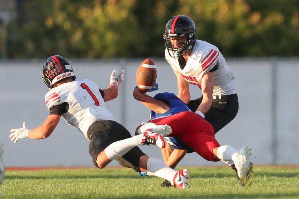 Boise defensive back Max Anderson (1) forces the ball loose from Nampa receiver Kartez Hernandez, and linebacker Duncan Thompson grabbed the interception on Sept. 8.