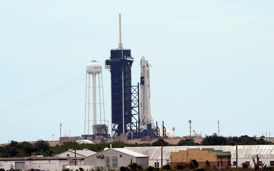 SpaceX Falcon 9 Original description: The SpaceX Falcon 9, with the Crew Dragon spacecraft on top of the rocket, is raised onto Launch Pad 39-A Tuesday - David J. Phillip /AP