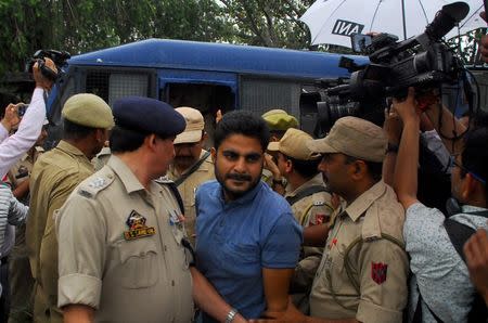 Deepak Khajuria arrives for a court appearance after he was arrested in connection with the rape and murder of an eight-year-old girl in Kathua, south of Jammu, April 16, 2018. REUTERS/Stringer