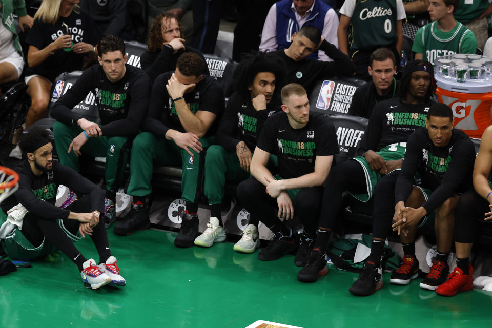 Members of the Boston Celtics sit on the bench in the closing minutes in Game 7 of the NBA basketball Eastern Conference finals Monday, May 29, 2023, in Boston. (AP Photo/Michael Dwyer)