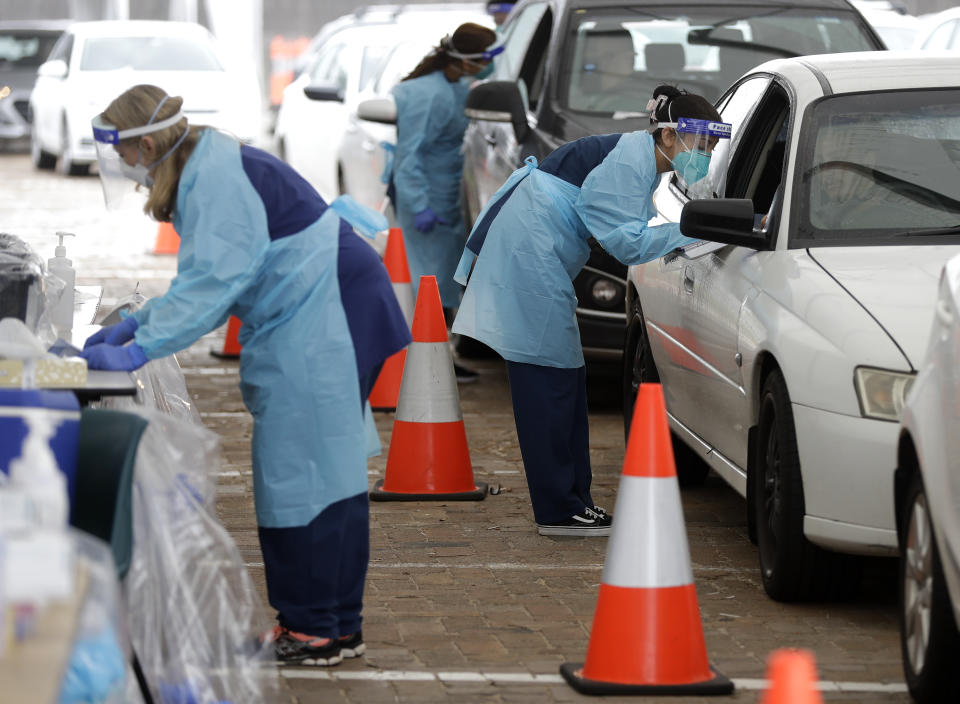 People attend a drive through COVID-19 testing station at a beach in Sydney, Australia, Saturday, Dec. 19, 2020. Sydney's northern beaches will enter a lockdown similar to the one imposed during the start of the COVID-19 pandemic in March as a cluster of cases in the area increased to more than 40. (AP Photo/Mark Baker)