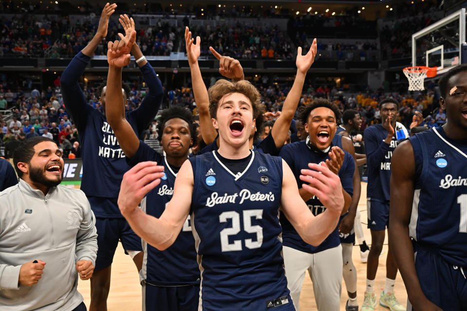 Doug Edert of the St. Peter's Peacocks and his teammates celebrate after defeating the Kentucky Wildcats in the first round of the 2022 NCAA men's basketball tournament. (Jamie Sabau/NCAA Photos via Getty Images)