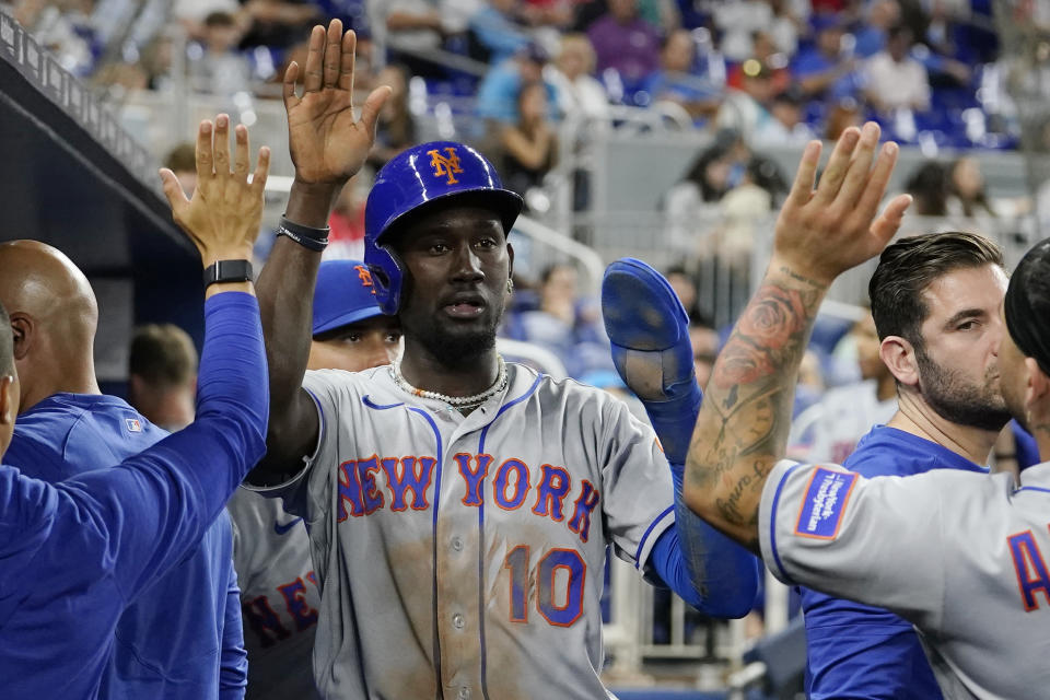 New York Mets' Ronny Mauricio is congratulated after scoring on a single hit by Mark Vientos during the fifth inning of a baseball game against the Miami Marlins, Monday, Sept. 18, 2023, in Miami. (AP Photo/Lynne Sladky)