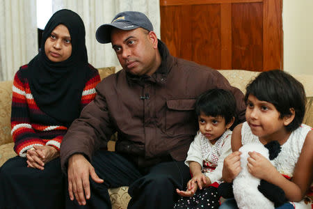 MD Chowdhury sits in his living room with his wife, Nazneen Fatema, and daughters, Nafia, 2, and Nabiha (R), 7, during an interview about lead safety improvements made to their lead contaminated home in Buffalo, New York March 30, 2017. REUTERS/Lindsay DeDario