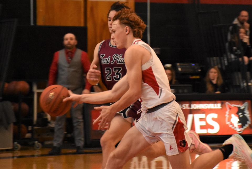 Oppenheim-Ephratah-St. Johnsville Wolf Collin Eakin drives past Fort Plain Hilltopper Nate Benson Nov. 24 on the way to the basket in the first round of the Coach Cutspec Tournament in St. Johnsville. The teams meet for the fourt time this season Friday in Fort Plain.