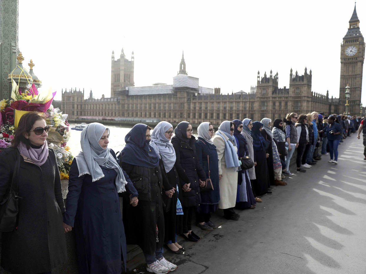 The women held hands in silence to remember victims of the terror attack in Westminster: Reuters