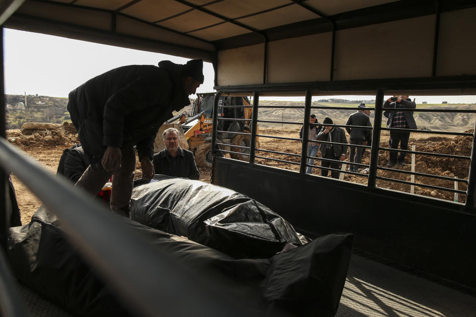 People prepare to bury their loved ones, victims of Monday earthquake, in Adiyaman, Turkey, Friday, Feb. 10, 2023. Emergency crews made a series of dramatic rescues in Turkey on Friday, pulling several people, some almost unscathed, from the rubble, four days after a catastrophic earthquake killed more than 20,000.(AP Photo/Emrah Gurel)