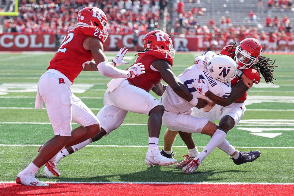 Sep 3, 2023; Piscataway, New Jersey, USA; Northwestern Wildcats quarterback Brendan Sullivan (6) is tackled by Rutgers Scarlet Knights defensive back Flip Dixon (10) and linebacker Mohamed Toure (1) and linebacker Tyreem Powell (22) during the second half at SHI Stadium. Mandatory Credit: Vincent Carchietta-USA TODAY Sports