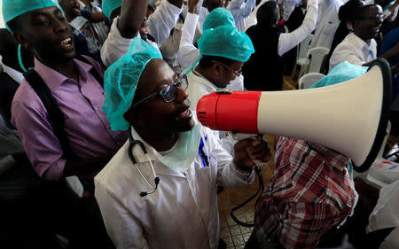 A Kenyan doctor uses a megaphone to shout a slogan to demand fulfilment of a 2013 agreement between their union and the government that would raise their pay and improve working conditions at a meeting in Nairobi, Kenya December 5, 2016. REUTERS/Thomas Mukoya
