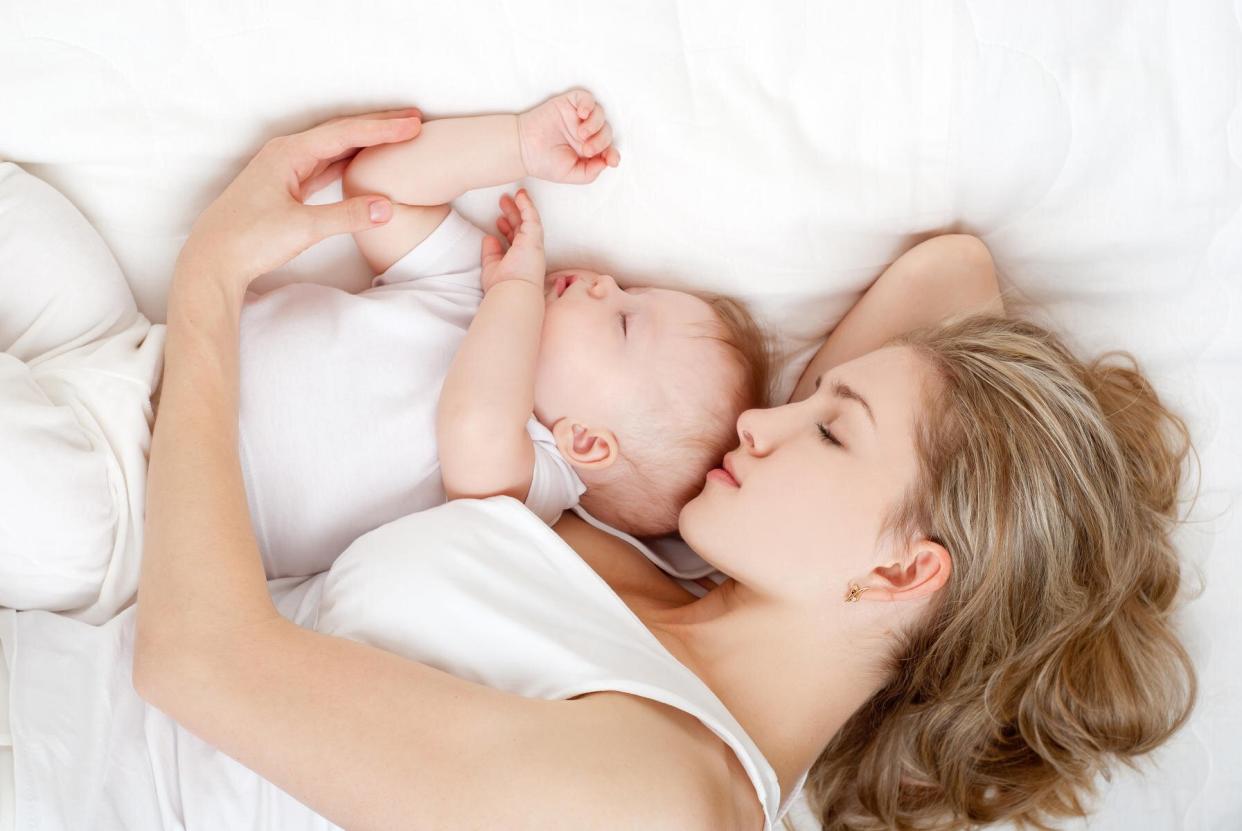 Woman Sleeping Next to Baby