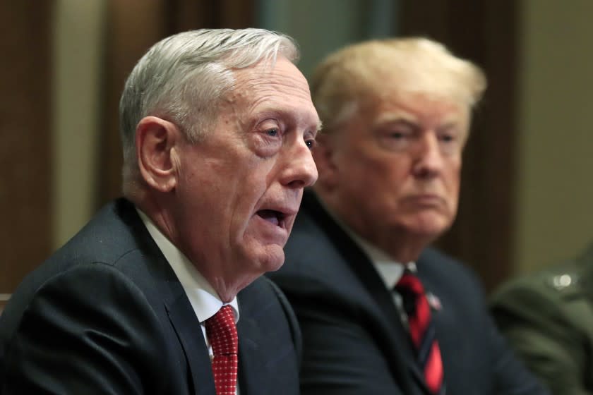 FILE - In this Oct. 23, 2018 file photo, Defense Secretary Jim Mattis speaks beside President Donald Trump, during a briefing with senior military leaders in the Cabinet Room at the White House in Washington. Mattis warns bitter political divisions have pushed American society to the "breaking point" in his most extensive public remarks since he resigned in protest from the Trump administration. (AP Photo/Manuel Balce Ceneta)