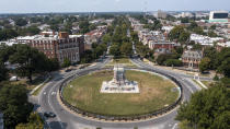 FILE - The pedestal that once held the statue of Confederate General Robert E. Lee stands empty on Monument Avenue in Richmond, Va., Tuesday, Sept. 14, 2021. The pedestal has been covered in graffiti, with some describing it as a work of protest art that should be left in place. (AP Photo/Steve Helber, File)