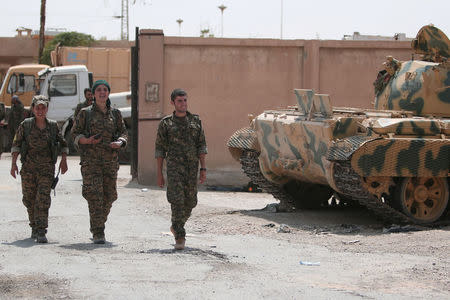 Kurdish fighters from the People's Protection Units (YPG) walk in the Ghwairan neighborhood of Hasaka, Syria, August 22, 2016. REUTERS/Rodi Said