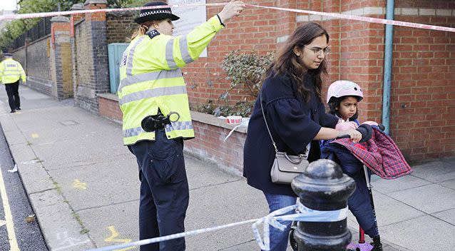 A child is evacuated from a nearby school. Source: AAP