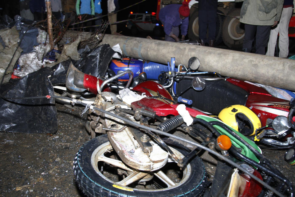 Wreckage of vehicles lie on the ground after a fatal accident in Londiani, Kenya early Saturday, July 1, 2023, at a location known for crashes about 200 kilometers (125 miles) northwest of the capital, Nairobi. Dozens were killed when a truck rammed into several other vehicles and market traders on Friday evening, police said. (AP Photo)