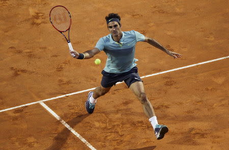 Roger Federer of Switzerland returns the ball to Pablo Cuevas of Uruguay during their tennis match at the Rome Open tennis tournament in Rome, Italy, May 13, 2015. REUTERS/Max Rossi