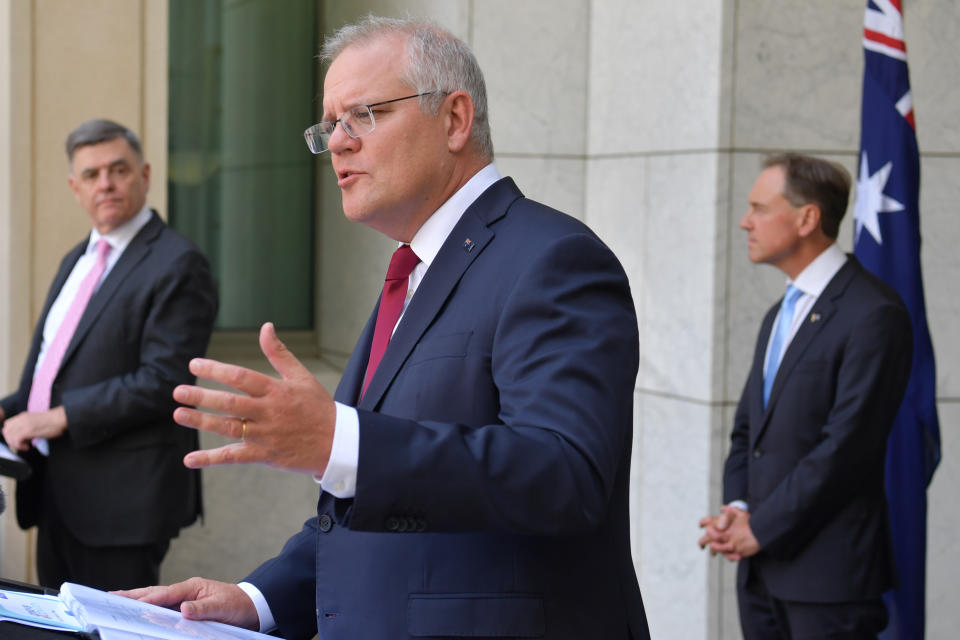 CANBERRA, AUSTRALIA - FEBRUARY 04: Department of Health Secretary Dr Brendan Murphy (left), Prime Minister Scott Morrison and Minister for Health Greg Hunt during a press conference in the Prime Minister's Courtyard at Parliament House on February 04, 2021 in Canberra, Australia. The Pfizer/BioNTech vaccine has been provisionally approved by the Therapeutic Goods Administration (TGA) for people 16 years and older with the COVID-19 vaccine to be available in Australia at 50 hospital sites across the country, and in residential aged care and disability facilities. (Photo by Sam Mooy/Getty Images)