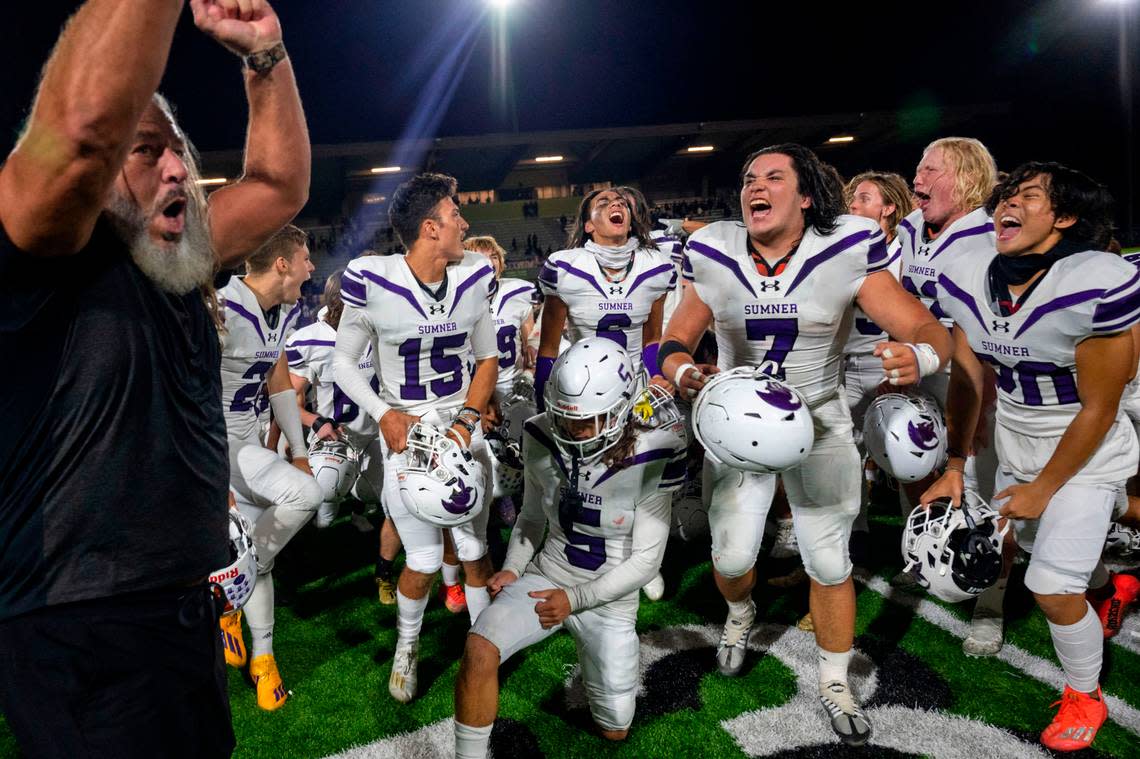 Sumner head coach Keith Ross leads the celebration after the Spartans beat Puyallup, 40-10 in a 4A SPSL game on Friday, Sept. 23, 2022, at Sparks Stadium in Puyallup, Wash.