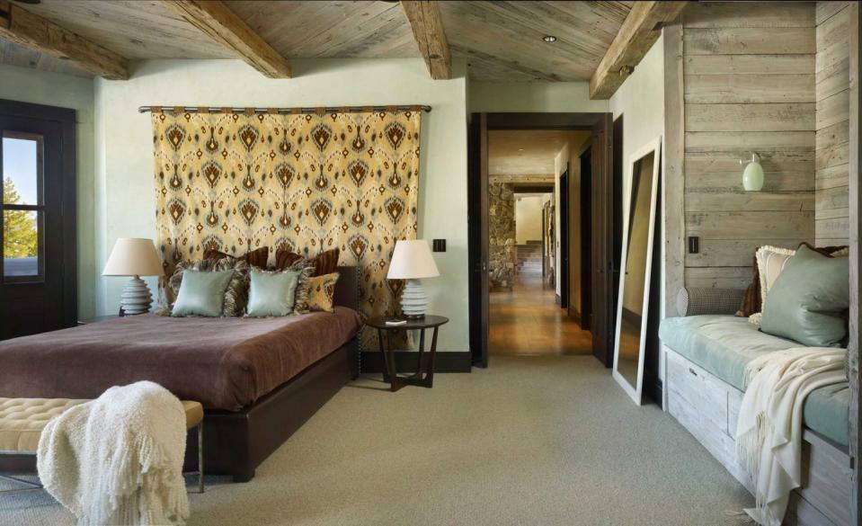 <p>Light wood accents, a patterned tapestry, and plush textures add charm and warmth to this cabin-style bedroom in Montana. Design by <a href="https://www.chairish.com/shop/lkid" rel="nofollow noopener" target="_blank" data-ylk="slk:LKID;elm:context_link;itc:0;sec:content-canvas" class="link ">LKID</a>. </p>
