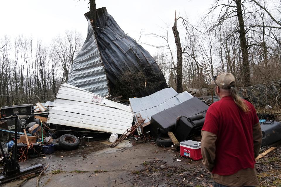 Dave Coleman assesses the damage to his Pataskala garage after a potential tornado touched down early Wednesday morning. Winds ripped off the roof to his workshop that was large enough to store a tractor-trailer.