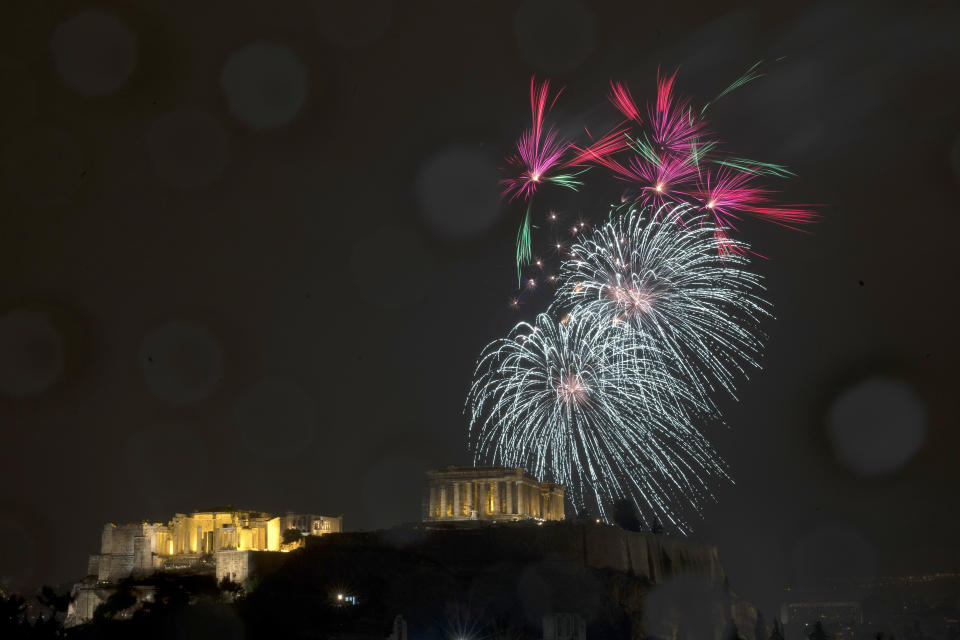 Fireworks explode over the ancient Parthenon temple at the Acropolis hill for the the New Year's Eve celebrations during a rainfall in Athens, Tuesday, Jan. 1, 2019. (AP Photo/Petros Giannakouris)