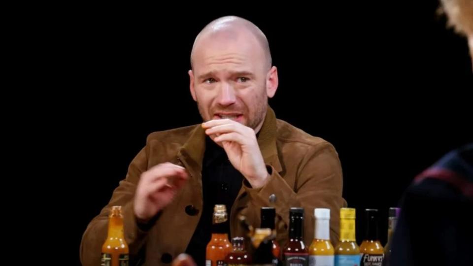 Sean Evans watches Conan O'Brien drink the last hot sauce on "Hot Ones" (First We Feast"