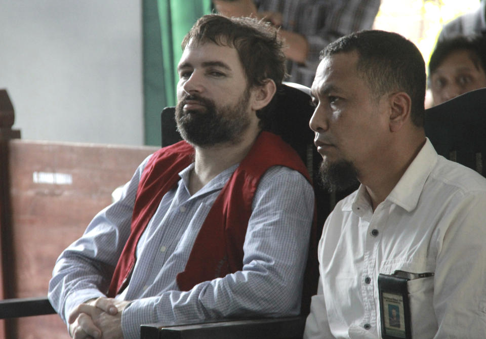 French national Felix Dorfin, left, is accompanied by an interpreter during his sentencing hearing at a district court in Mataram, Lombok Island, Indonesia, Monday, May 20, 2019. The court on Monday sentenced Dorfin to death for smuggling 3 kilograms (6.6 pounds) of drugs to the tourist island of Lombok, even though prosecutors had only sought a 20-year sentence. (AP Photo)