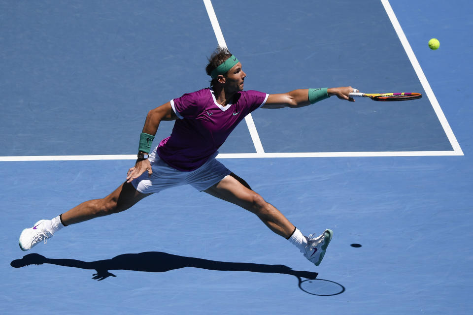 Rafael Nadal of Spain plays a backhand return to Yannick Hanfmann of Germany during their second round match at the Australian Open tennis championships in Melbourne, Australia, Wednesday, Jan. 19, 2022. (AP Photo/Andy Brownbill)