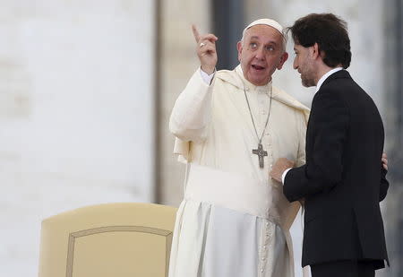 Pope Francis speaks to Renewal in the Holy Spirit movement's president Salvatore Martinez (R) as he leads a special audience in Saint Peter's Square at the Vatican July 3, 2015. REUTERS/Alessandro Bianchi