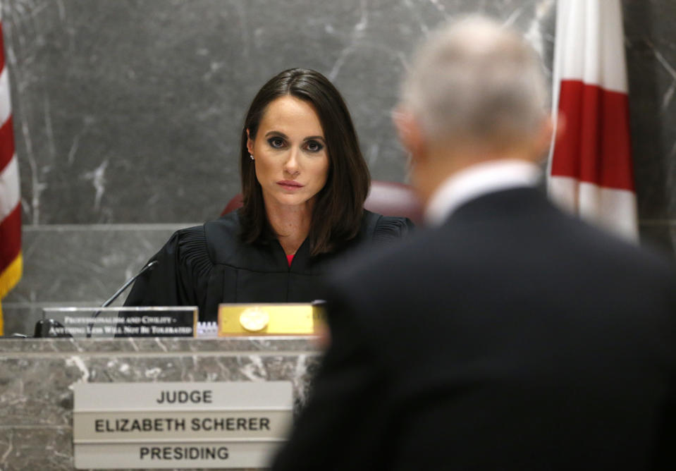 Judge Elizabeth Scherer, rear, listens to chief assistant state attorney Jeff Marcus during hearing for school shooting suspect Nikolas Cruz in a Broward County courtroom in Fort Lauderdale, Fla., Friday, Aug. 3, 2018. Attorneys for Cruz want a judge to prevent release of details of his education records to guarantee a fair trial. Cruz faces the death penalty if convicted of killing 17 people in the Valentine's Day attack at Marjory Stoneman Douglas High School. (AP Photo/Wilfredo Lee, Pool)
