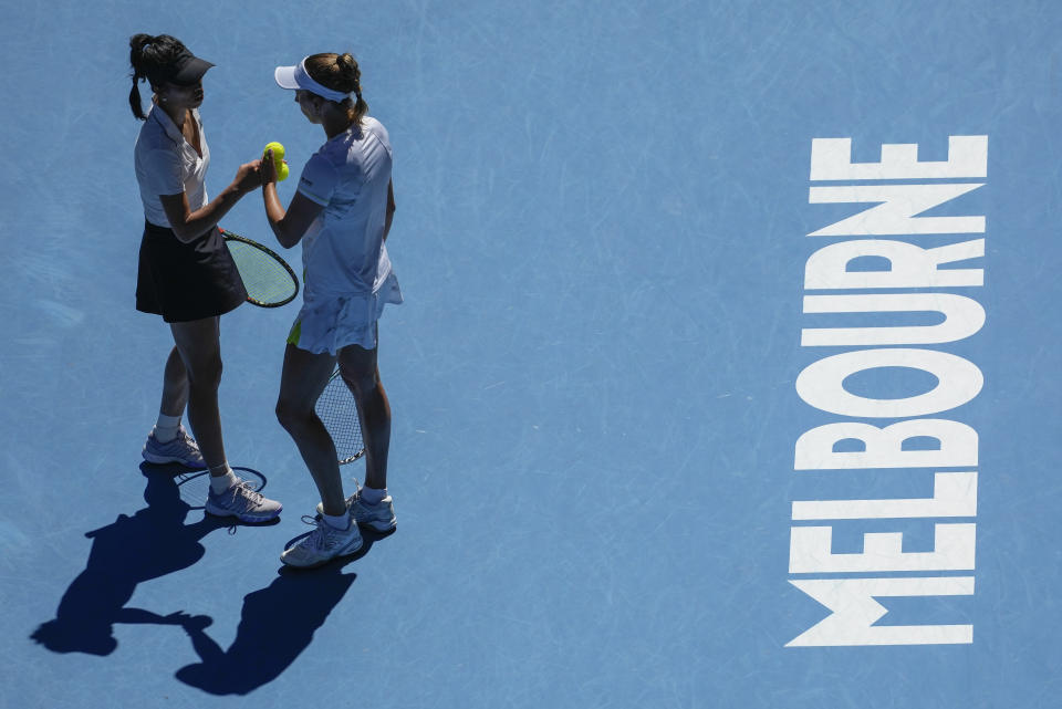 Hsieh Su-Wei, left, of Taiwan and Elise Mertens of Belgium talk during the women's doubles final against Jelena Ostapenko of Latvia and Lyudmyla Kichenok of Ukraine at the Australian Open tennis championships at Melbourne Park, in Melbourne, Australia, Sunday, Jan. 28, 2024. (AP Photo/Louise Delmotte)