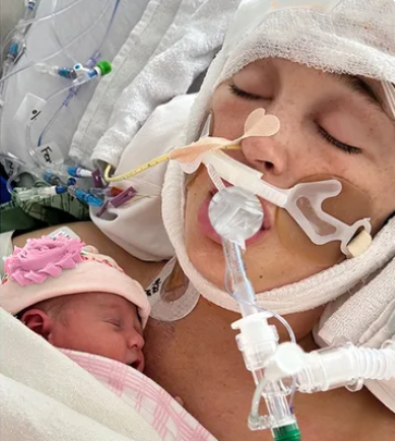 Jackie Miller James, in a coma, with her newborn daughter. (GoFundMe)