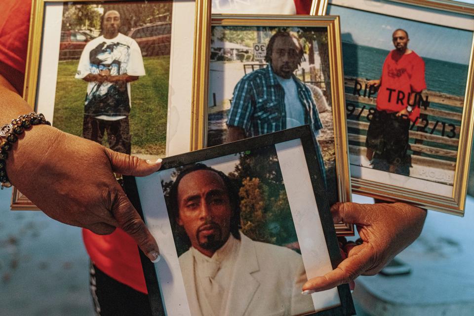 Casa Bean Robinson holds portraits of her son Dontrunner.