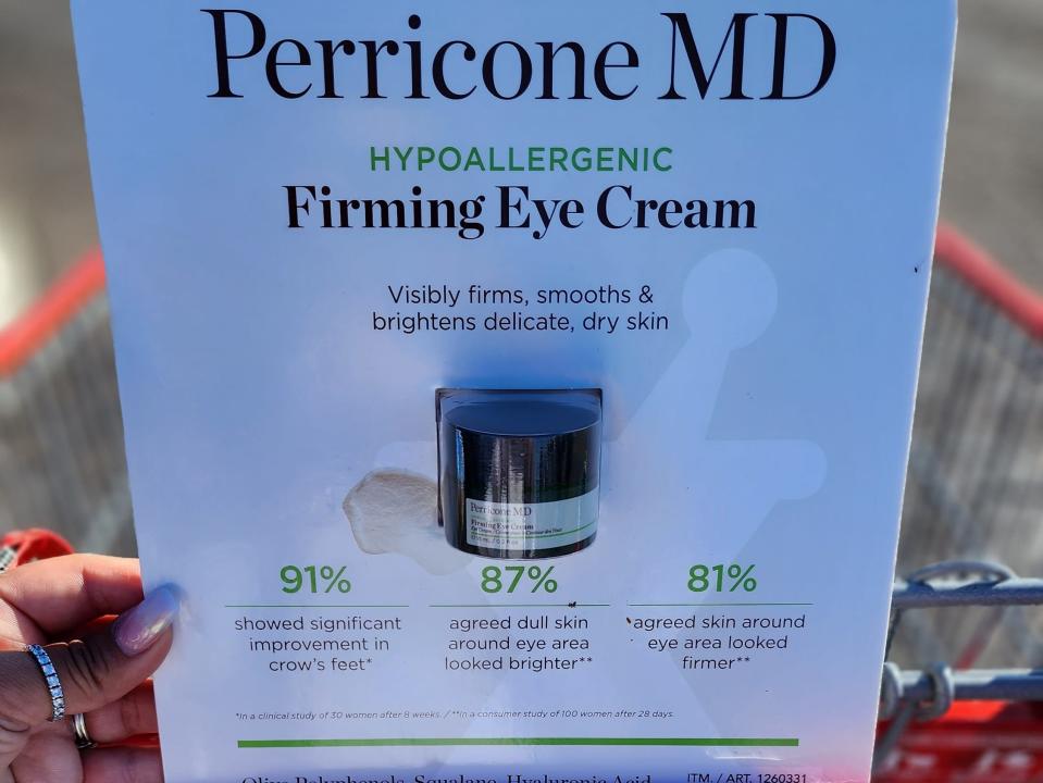 The writer holds a package with a Perricone MD firming eye cream